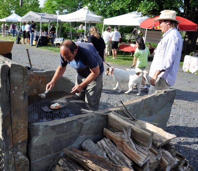 Jerry Fritz, owner of Linden Hill Gardens, makes pizza on the grill at the Ottsville Farmers Market.