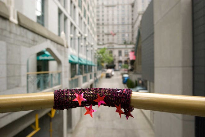 This undated photo courtesy of Jeff Christenson shows "Yarn Bombed Railing," a mixed-media tag in Vancouver, Canada from "Yarn Bombing: The Art of Crochet and Knit Graffiti," by Leanne Praine and Mandy Moore. The first International Yarn Bombing Day is set for June 11. Promoted on Prain's Yarn Bombing web site, and on its own web site and Facebook page, the event is meant to encourage crafters to tag something and then post about it. (AP Photo/Jeff Christenson)