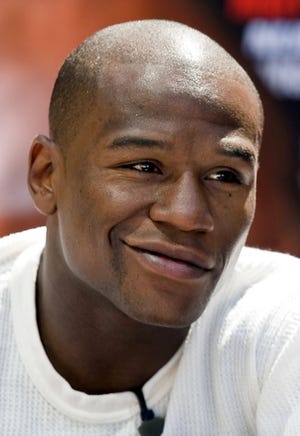 This May 18 2009 file photo shows Floyd Mayweather Jr. at a news conference in Los Angeles. Mayweather has said that every fight he takes beginning with Mosley will include Olympic-style blood testing along with the typical urine tests required by most athletic commissions. That means the fighters could have blood drawn in the days leading up to the fight. (AP Photo/Mark Avery File)