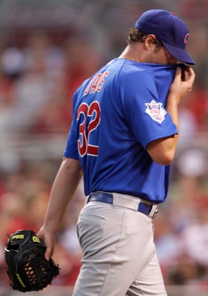 Chicago Cubs starting pitcher Doug Davis walks off the field after being taken out in the fifth inning of a baseball game against the Cincinnati Reds, Tuesday, June 7, 2011 in Cincinnati. Davis was the losing pitcher in the game won by Cincinnati 8-2.