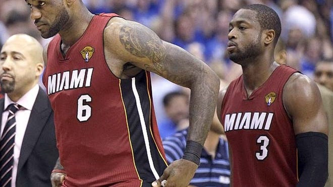 Miami's LeBron James (6) and Dwyane Wade walk off the court dejectedly after falling to Dallas 86-83 in Game 4 of the 2011 NBA Finals. The series is tied 2-2, with Game 5 on Thursday.