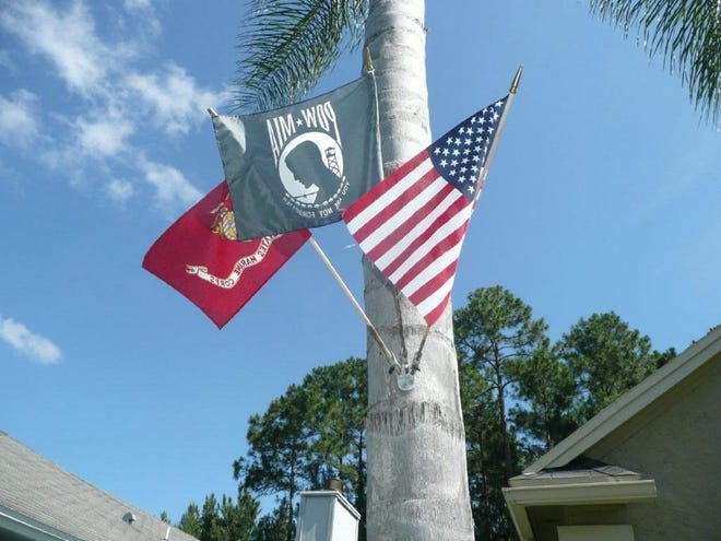 Klaus Maurer flies the U.S. flag, a POW/MIA flag and the U.S. Marines flag at his home.