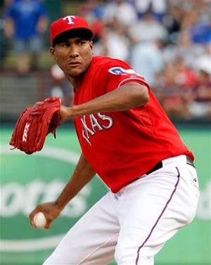 Texas Rangers pitcher Alexi Ogando throws a pitch in the first inning of a baseball game against the Detroit Tigers at Rangers Ballpark in Arlington, Texas, Wednesday June 8, 2011.