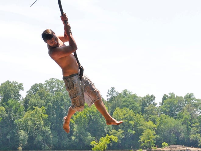 Michael Hill swings on a vine on Tuesday while swimming in the Coosa River at Corn Creek Park in Wetumpka.