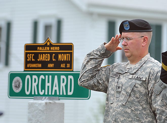 Colonel John Chapman salutes during the presentation of the colors at the Jared C. Monti dedication in Raynham.