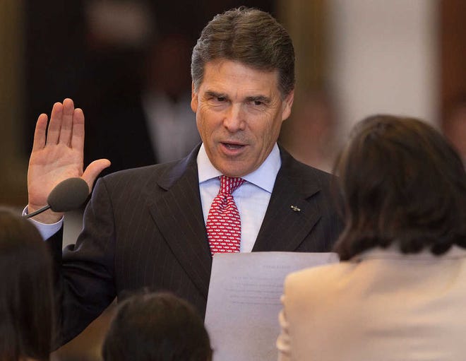 Gov. Rick Perry gives the oath Friday during the investiture of Judge Elsa Alcala to the Texas Court of Criminal Appeals in the House of Representatives in Austin.