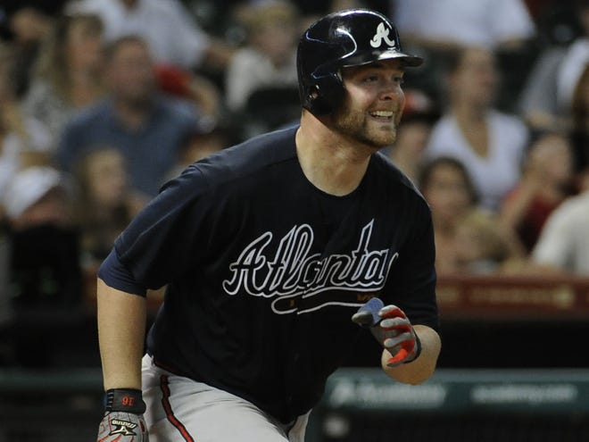 Atlanta's Brian McCann smiles after hitting a three-run homer in the 10th inning to help the Braves topple Houston on Saturday night.