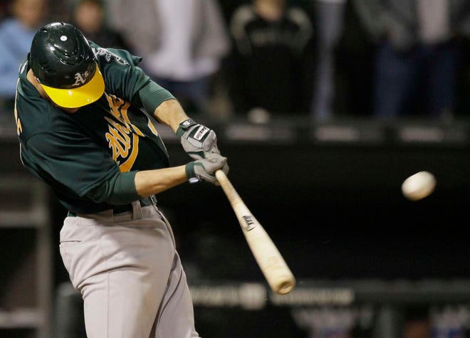The Oakland Athletics' Scott Sizemore hits a three-run double against the Chicago White Sox during the ninth inning Friday, June 10, 2011, in Chicago. The Athletics won 7-5.