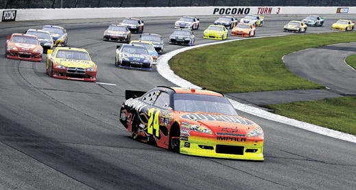 Jeff Gordon leads the pack on a restart on his way to winning the NASCAR Sprint Cup Series auto race in Long Pond, Pa., Sunday, June, 12, 2011. (AP Photo/Mel Evans)