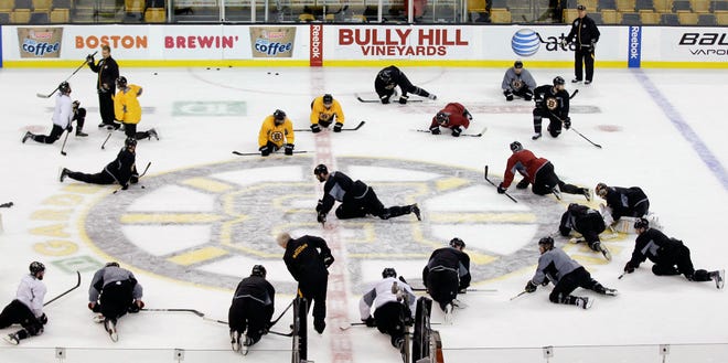 Boston Bruins defenseman Zdeno Chara, center, leads the team in stretching at the end of practice for Game 6 of the NHL hockey Stanley Cup finals against the Vancouver Canucks, Sunday, June 12, 2011, in Boston. Game 6 is scheduled for Monday in Boston.