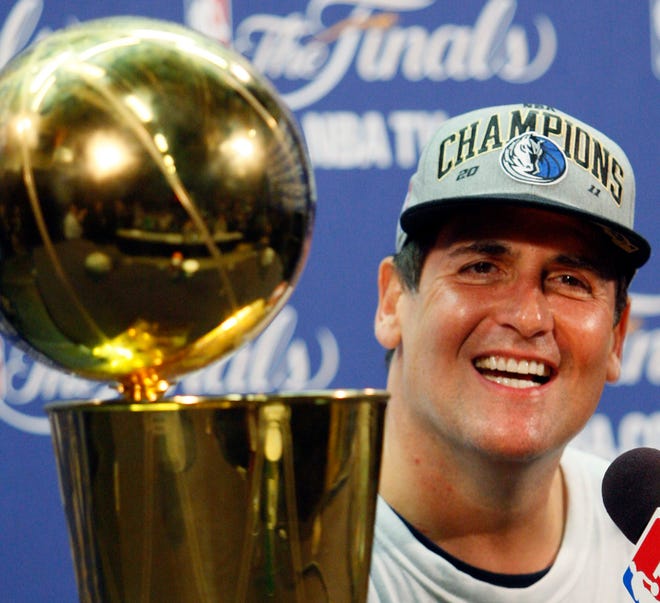 Dallas Mavericks owner Mark Cuban smiles during a news conference after Game 6 of the NBA Finals basketball game against the Miami Heat Sunday, June 12, 2011, in Miami. The Mavericks won 105-95 to win the series.