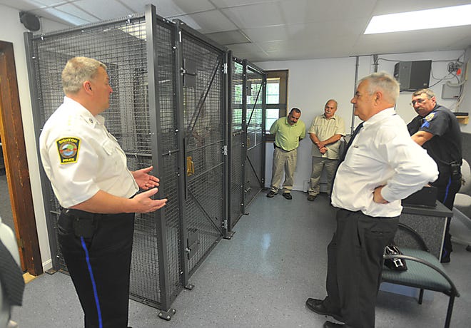 Dighton Police Chief Robert MacDonald, left, shows 
Congressman Barney Frank, right, the holding cells at the Dighton Police Station.