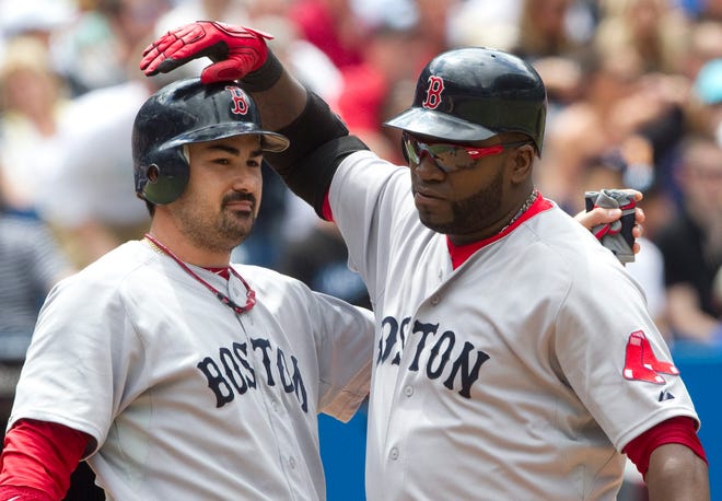 The Red Sox' David Ortiz, right, and Adrian Gonzalez celebrate Ortiz's three-run home run in the fifth inning of Sunday's game against the Blue Jays in Toronto.