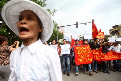 Vietnamese protesters march down the streets in a protest demanding China to stay out of their waters following China's increased activities around the Spratly Islands and other disputed areas, in Hanoi, Vietnam on Sunday June 12, 2011. (AP Photo/Na Son Nguyen)