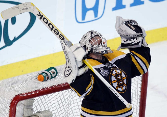 Boston Bruins goalie Tim Thomas celebrates his team's 5-2 win over the Vancouver Canucks in Game 6 of the NHL hockey Stanley Cup Finals in Boston, Monday, June 13, 2011. The Bruins' victory sends the series to Game 7 Wednesday night in Vancouver, British Columbia. (AP Photo/Charles Krupa)