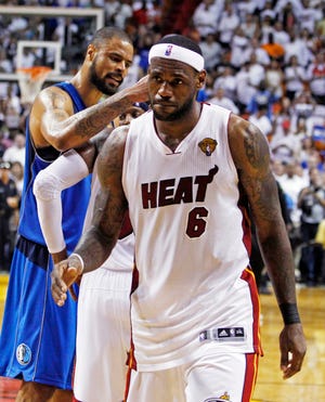 Miami Heat forward LeBron James walks off the court Sunday after losing Game 6 of the NBA finals against the Dallas Mavericks. By LYNNE SLADKY, The Associated Press