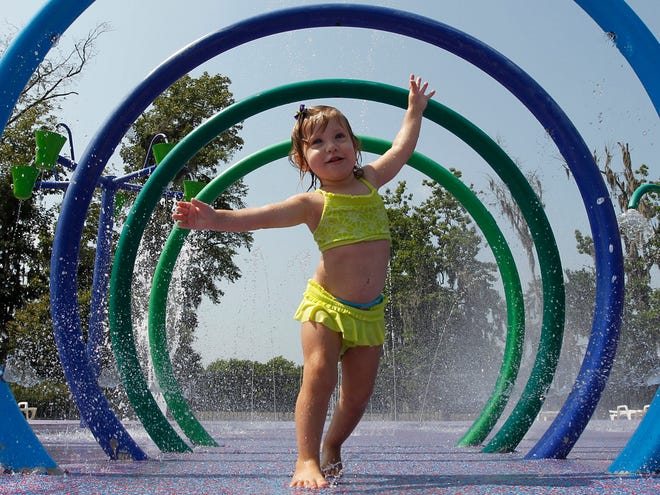 Alivia Parker, 21 months, runs through circles of spraying water on a 100-degree day in Montgomery, Ala., Tuesday, June 14, 2011. Parker is wearing sunscreen with an SPF of 100. Federal regulators will require sunscreen manufacturers to test their products' effectiveness against sun rays that pose the greatest risk of skin cancer. Under new rules, manufacturers also will have to follow stricter guidelines when describing how well their products block ultraviolet B rays. (AP)