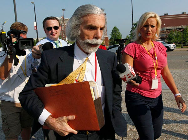 Reporters pursue attorney Bobby Seagall as he arrives at the Federal Building in Montgomery, Ala., Tuesday, June 14, 2011 for a trial on federal bribery and conspiracy charges in a vote buying scheme in the Alabama Senate. Seagall represents casino owner Milton McGregor who is on trial with eight other defendants. (AP Photo/Dave Martin)