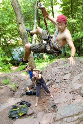 Ryan Hood of Limerick swings back to the rock face as his friend
Kati Sheronos of Valley Forge (below) holds the line as he scales
the High Rocks Vista at Ralph Stover State Park in Tinicum. Rick
Kintzel/Staff Photographer