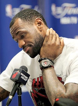 Miami Heat forward LeBron James listens to a question during a news conference Tuesday in Miami. Instead of hosting Game 7 of the NBA finals, the Heat packed up their things for the summer. By WILFREDO LEE, The Associated Press