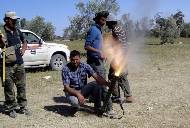 Rebel fighters fire their mortars towards pro-Moammar Gadhafi forces at the front line of Dafniya about 25 miles west of Misrata, Libya, on Wednesday.