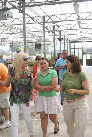 Photo by Bruce Scruton/New Jersey Herald 
Wendy Blanchard, left, explains the hydroponic gardening operations of Arthur & Friends to Sara, center, and Mary Pat Christie, daughter and wife of Gov. Chris Christie, Thursday at the Conservancy at the Sussex County 
Fairgrounds in Frankford.