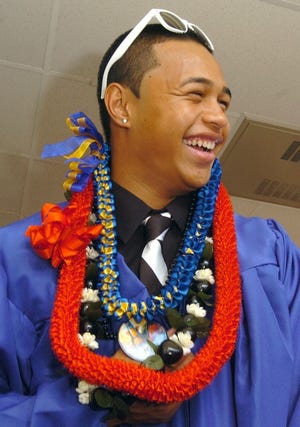 Maple Shade High School graduating senior, Pakela Borges wears
symbolic leis from his home, Hawaii, as he jokes with his
classmates prior to the commencement.