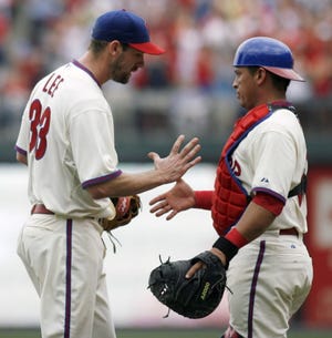 Phillies starting pitcher Cliff Lee (left) celebrates with
catcher Carlos Ruiz after their 3-0 win over the Florida Marlins on
Thursday. Lee tossed a two-hitter and had two hits and an RBI in
the game.