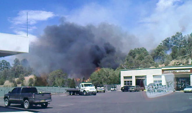 Smoke is shown from a fire Thursday June 16, 2011 in Ruidoso, N.M. Firefighters battled a blaze that erupted behind a Ruidoso business and quickly raced up the mountain behind it, engulfing homes along the way. (AP Photo/Ruidoso News, Dina Garner)