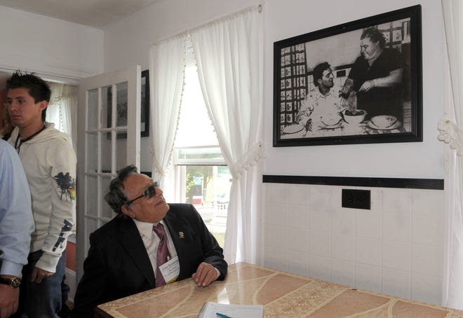 World Boxing Council President Jose Sulaiman looks at a photograph of Rocky at his boyhood home in Brockton, on Tuesday, June, 14, 2011. The World Boxing Council announced Tuesday it would fund a statue of the late heavyweight champion Rocky Marciano to be erected in the city.