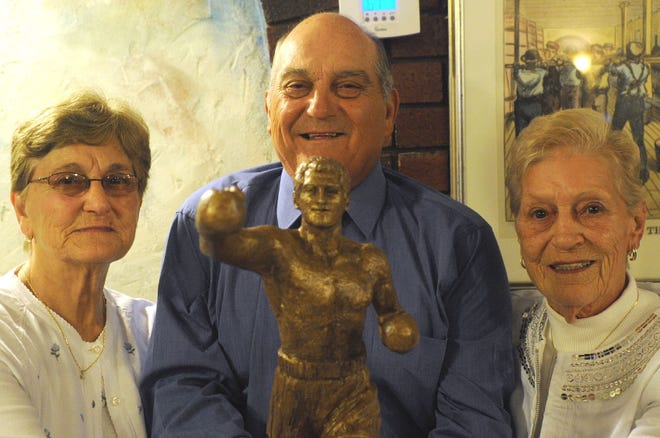 Boxing legend Rocky Marciano's sister Elizabeth Colombo, brother Peter Marciano, and sister Alice Pereira pose with the model for the planned statue of Rocky during an invitation-only reception at George's Cafe in Brockton for the visiting World Boxing Council on Monday, June 13, 2011.