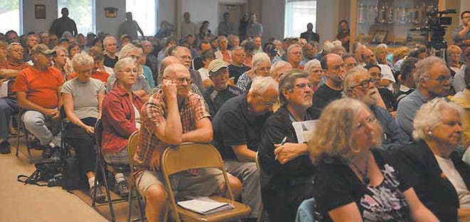 Members of the public listen to a presentation on plans to accept Marcellus Shale drill cuttings at Steuben County landfills Monday at the Bath Fire Hall.