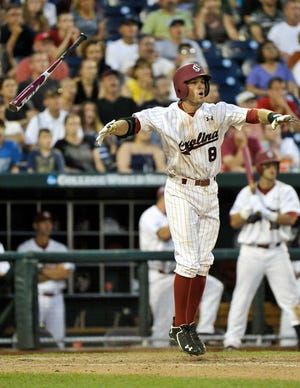 South Carolina's Scott Wingo jumps after knocking in the winning run against Texas A&M in the ninth inning on Sunday in Omaha, Neb. USC beat A&M, 5-4.
