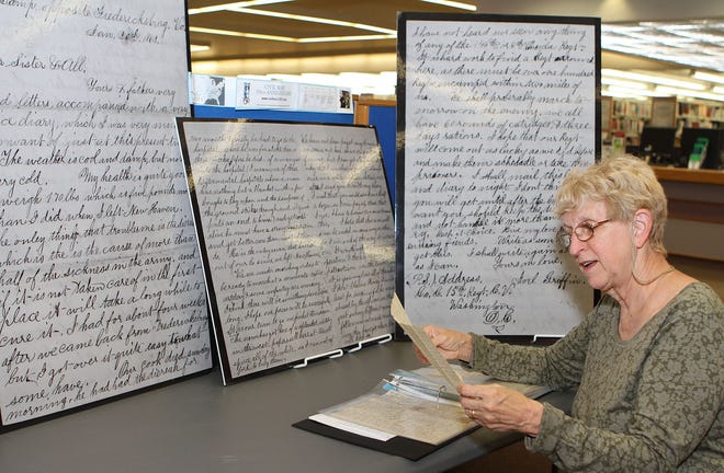 Marilynn Fuller, a part time staff member at the Bellingham Public Library, reads a letter written in 1863 by Joel Griffen, her great-grandfather, when he was fighting in the Civil War. Fuller showed her collection of letters recently as she sat next to the library’s display commemorating the writing of the letters and the 150th anniversary of the start of the Civil War.