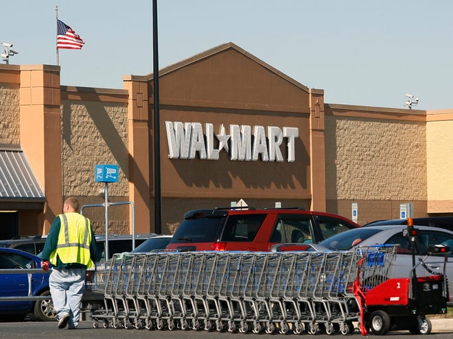 In this March 17, 2010 file photo, a worker gathers shopping carts near a Wal-Mart store in Washington Township, N.J. The Supreme Court has ruled for Wal-Mart in its fight to block a massive sex discrimination lawsuit on behalf of women who work there. (AP Photo)