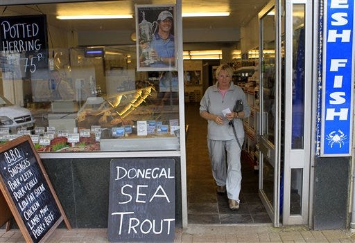 A picture of Rory McIlroy holding the U.S. Open Trophy in a fish shop in Holywood, Northern Ireland, Tuesday, June, 20, 2011. The village situated on the outskirts of Belfast has been celebrating McIlroy winning the U.S. Open Golf Championship.