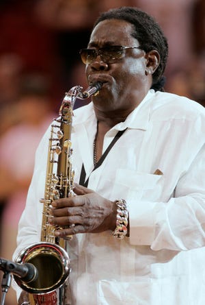 In this Feb. 10, 2008 file photo, Clarence Clemons plays the national anthem before a basketball game between the Miami Heat and Los Angeles Lakers in Miami. The funeral service for Clemons, 69, who died Saturday, June 18, 2011, of complications from a stroke, was held Tuesday, June 21, 2011, at the Royal Poinciana Chapel in Palm Beach. Music filled the church during the private funeral for the longtime saxophonist in Bruce Springsteen's E Street Band. (AP Photo/Lynne Sladky, Fiule)