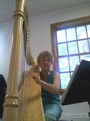 Elizabeth Solomen of Moorestown plays the pedal harp at You
Gotta Have Harp summer camp, which started Monday at the Burlington
Meeting House and Conference Center in Burlington City.