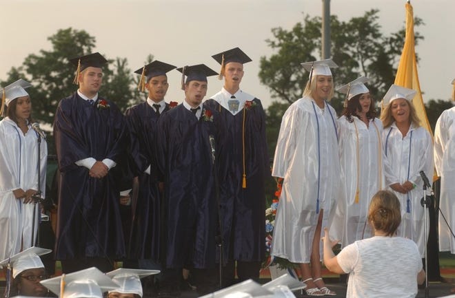 Senior class choir members sing "Open Arms", during the 2011
Florence High School graduation ceremony Tuesday at the athletic
stadium.