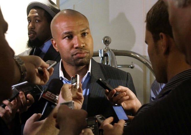 Los Angeles Lakers player Derek Fisher holds a briefing following a meeting between owners and players Tuesday.