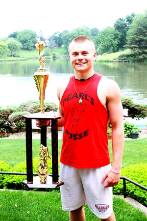 Colton Schulenberg, a senior at Orion High School, poses with the trophy he won as the overall MVP at the National Underclassmen Combine.