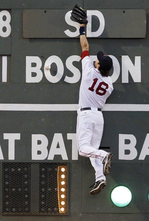 Boston Red Sox left fielder Josh Reddick leaps but cannot catch a double by San Diego Padres' Anthony Rizzo during the third inning of a baseball game at Fenway Park in Boston on Tuesday, June 21, 2011.