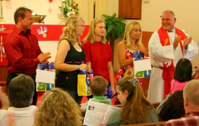 HONORED at Hope Lutheran Church are graduates Jarrod Bertsch of Florida Institute of Technology, from left, Krystal Parrish of Polk State Collegiate High School and Sabrina Parrish of Plant City High School. Cindy Petersen accepts for her son, Andy, of Plant City High School. At right is Hope's the Rev. Dean Pfeffer.