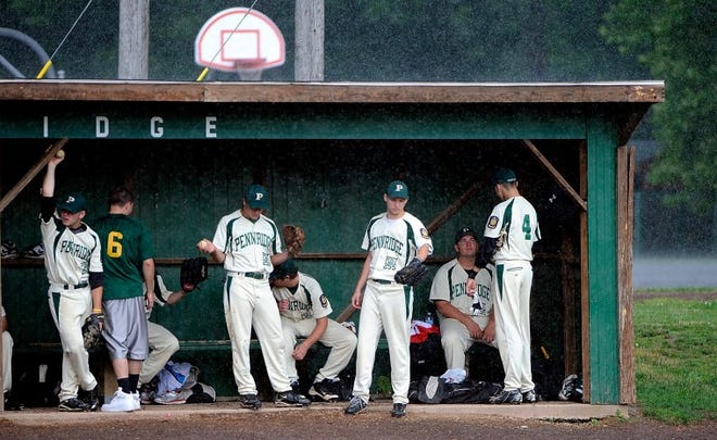 The Pennridge bench can only sit and wait as a brief but heavy
shower moves through the area causing the cancellation of an
American Legion baseball game between Pennridge and Lansdale at
Kulp Playground in Perkasie Friday.
