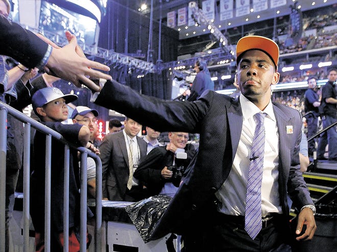 Kyrie Irving, a former Duke basketball player, is congratulated after being take with the No. 1 pick by the Cleveland Cavaliers during the NBA basketball draft, Thursday, June 23, 2011, in Newark, N.J.