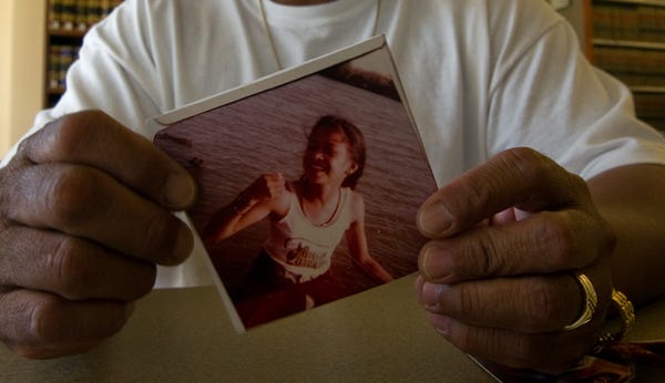 Joseph Rontal holds a photograph of his sister, Renee, who was slain along with Nancy Rubia in 1982.