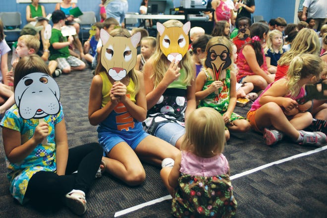 The Unsworth girls and friends wear their "Wild Florida" animal masks on June 21 at the Main Branch library, 1960 N. Ponce de Leon Blvd., during a free library program.