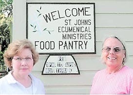 Carolyn Blake and Pat Mahr in front of the food pantry entrance. Contributed photos
