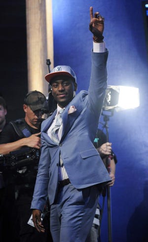 Connecticut's Kemba Walker, who was selected with the No. 9 pick by the Charlotte Bobcats, waves during the NBA basketball draft Thursday, June, 23, 2011, in Newark, N.J.