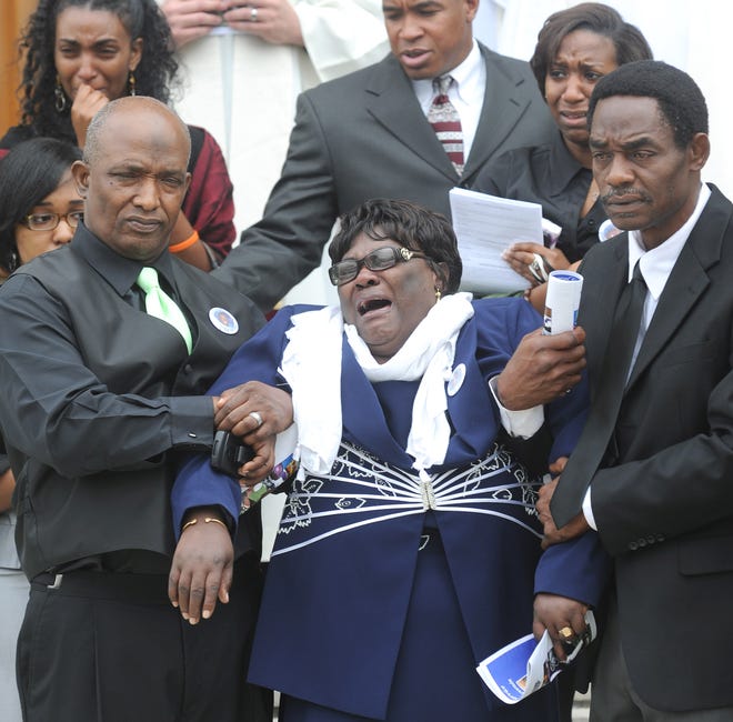 Thevenin’s aunt, Marie, is overcome with emotiion as she follows her nephew's casket out of the church.